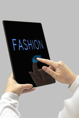 Fashion message on digital tablet computer display. Woman hands