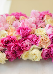 floral arrangement of pink peonies and cream roses