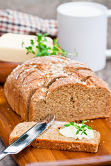 Sliced Irish stoneground soda bread with butter and thyme on the