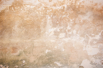 Weathered and peeled off orange concrete wall texture background with vignetting.