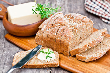 Sliced Irish stoneground soda bread with butter and thyme on the