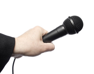 A black microphone being held by a man's hand. Isolated on white.