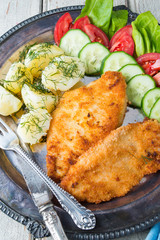 Fried chicken steak,boiled potatoes and vegetable salad
