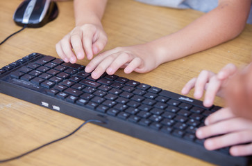 Computer keyboard with kids hands