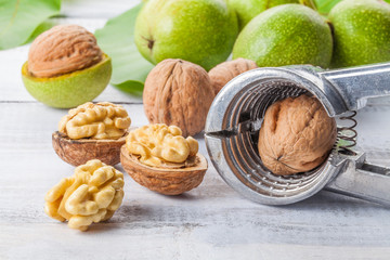 Walnuts and nutcracker on wooden table