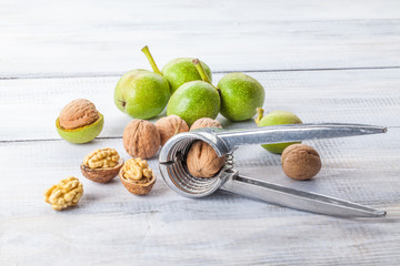 Walnuts and nutcracker on wooden table