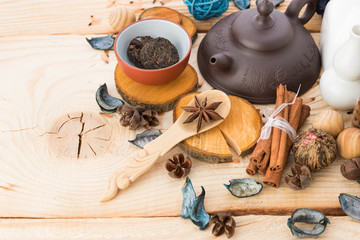 dry tea leaves cinnamon and on wooden background