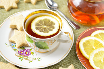 Homemade star cookies with tea and lemon