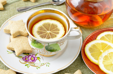 Homemade star cookies with tea and lemon