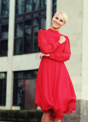 Happy beautiful woman in red summer dress