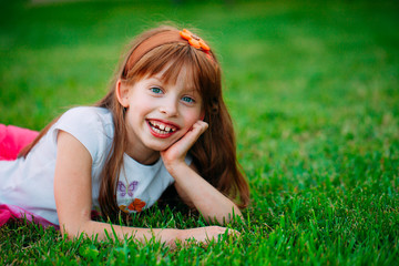 Little girl lying on the grass