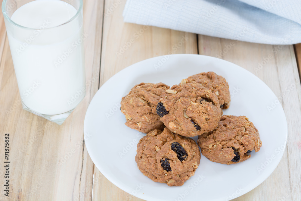 Sticker delicious raisin cookies and a glass of milk