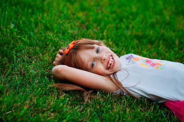 Little girl lying on the grass