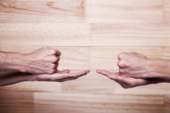 Two People Playing Rock Paper Scissors. Tied Game.