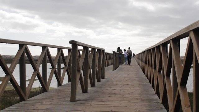 Algarve QDL Ria Formosa Park People Walking in Wood Bridge, Portugal.