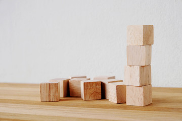 Wooden cubes on table over cement wall background