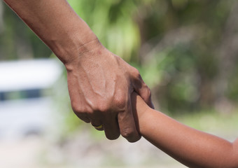 Fathers of children holding hands.