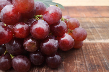 Bunch of red grapes on wooden table