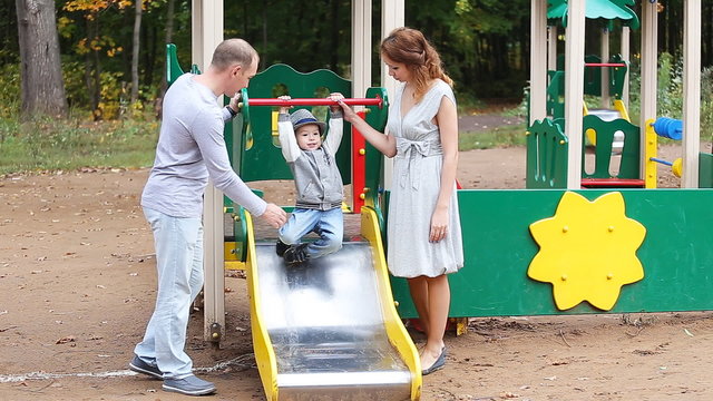 Dad Mom And Child Playing On Playground