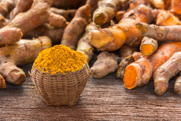Close up turmeric powder on grunge wooden background.