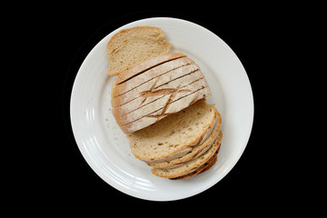 Baked bread on a white plate, Black Background isolated
