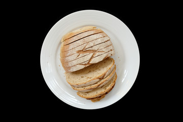 Baked bread on a white plate, Black Background isolated