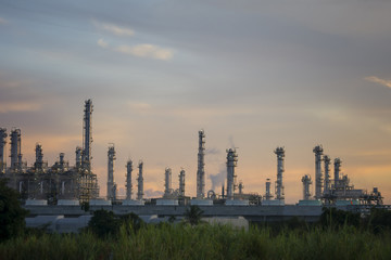 Fototapeta na wymiar Silhouette of petrochemical plant or Oil and gas refinery in sunrise