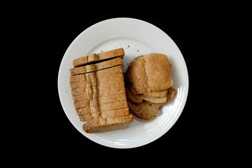 Baked bread on a white plate, Black Background isolated