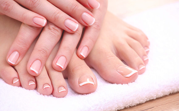 Closeup photo of a beautiful female feet with red pedicure