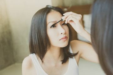 Fototapeta premium Young asian woman make up yourself