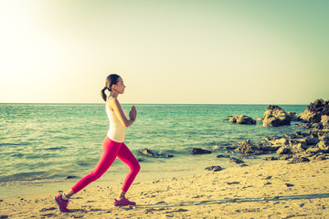 Young woman yoga action on the beach