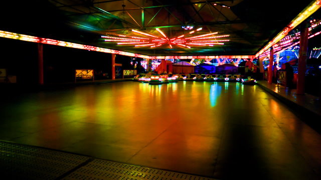 Colorful carnival bumper cars at night in timelapse. FullHD 1080p.