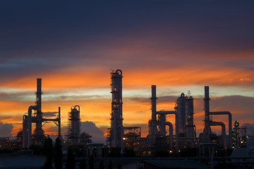 Fototapeta na wymiar Silhouette of petrochemical plant or Oil and gas refinery in sunrise