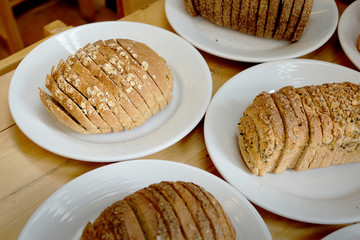 Baked bread on white plate and wooden table with Selective focus.
