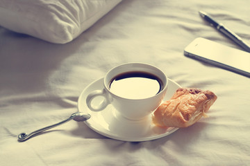  coffee cup and pie in the morning on the bed background, vintage tone