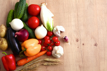 Composition with assorted raw organic vegetables wooden table