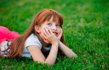Little girl lying on the grass