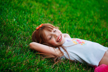 Little girl lying on the grass