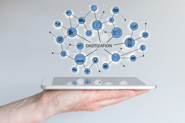 Digitization and digital disruption concept. Male hand holding modern tablet or smart phone with illustration of connected devices and information. - obrazy, fototapety, plakaty