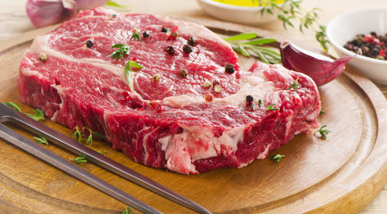 Raw Steak on  wooden  table.
