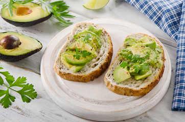 Healthy sandwiches with avocado and herbs.