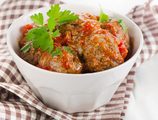 Meatballs with  fresh parsley leaves.