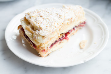 Slice of Mille Feuille cake with jam and cream, selective focus