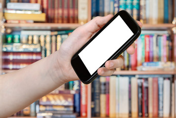 hand holds smart phone in library