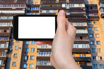 smartphone and facade on appartment house