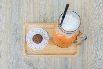 Top view of Iced milk Tea and cookie on wooden tray