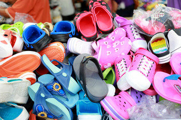 Colorful pile shoes in the market.