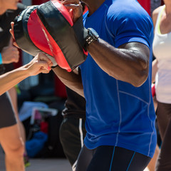 Man at Gym doing Fitness with Punching Mitts