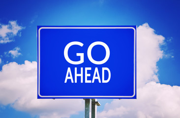 Go ahead text on blue traffic sign