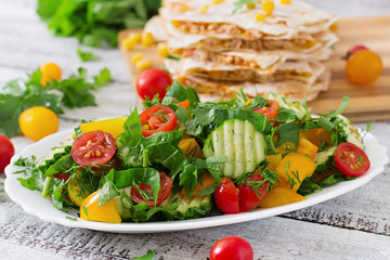 Fresh salad of tomatoes, cucumbers, peppers, arugula and dill